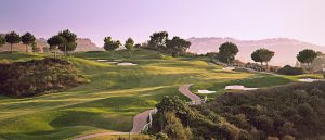 One of the holes at the La Cala America golf course with the sun shining on the fairway.