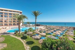 Pool at the Vik Gran hotel with sun beds and beautiful blue sea in the background.
