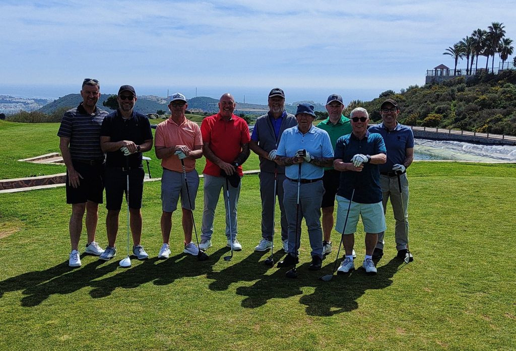 Golfers posing for a group photo.