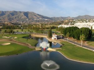 Mijas Los Lagos course from the air showing the lakes and mountains in the background.