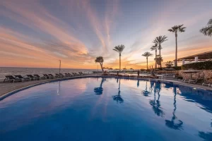 Hotel Estival swimming pool at night with the sun going down.