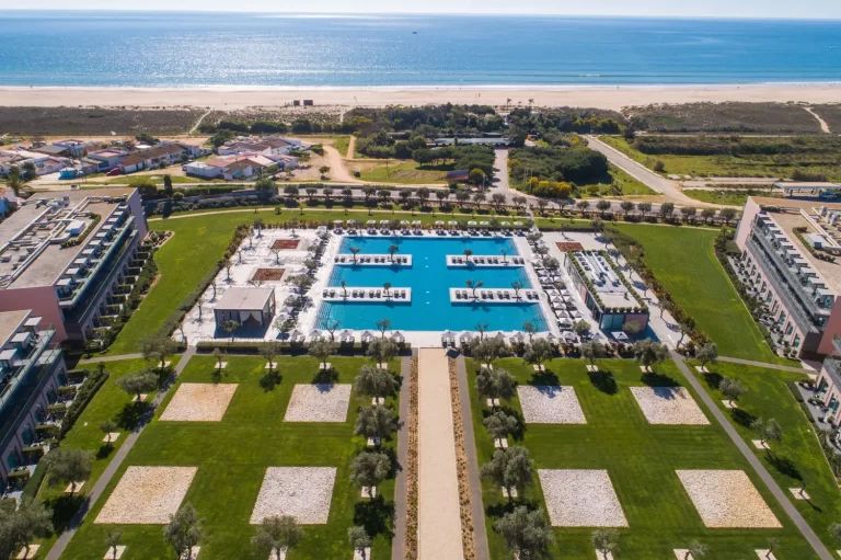 Hotel Vila Gale Lagos pool and grounds from above with views to the ocean in the background.