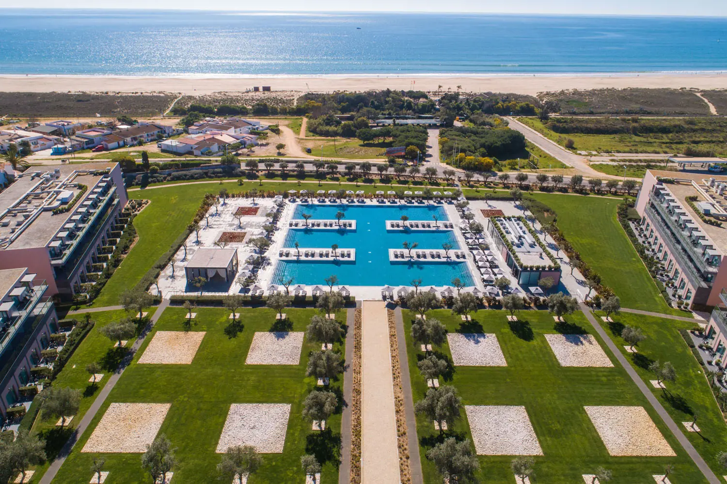 Hotel Vila Gale Lagos pool and grounds from above with views to the ocean in the background.