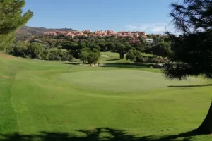 Scenic view of Santa Maria Golf Course featuring lush green fairways and surrounding trees under a clear blue sky.