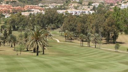 One of the fairways at El Paraiso Golf with well manicured grass and residential properties in the distance.