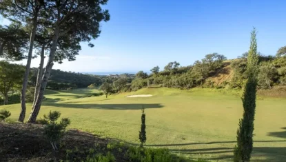 Scenic view of Santa Maria golf course with lush green fairways and surrounding trees under a clear blue sky.